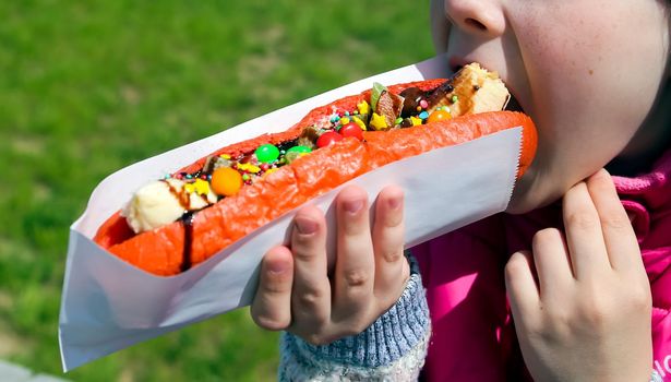 sweet american hot dog with banana, chocolate and marshmallows