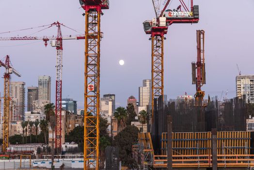 TEL AVIV, ISRAEL - MAY 01 2022: Somail complex in Tel Aviv in the evening with the moon rising. Construction work on the new Tel Aviv Municipality building. Ibn Gvirol Urban Renewals. High quality photo