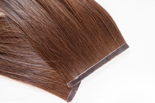 The process of preparing a hair ribbon for extension at home. Hair extensions to thicken your own. Individual strands of hair close-up