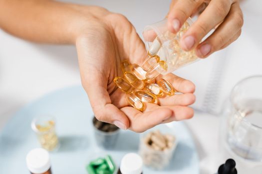 BADS Capsules of Omega-3 biologically active dietary supplements in hands close-up. Vitamin D for building and maintaining healthy bones