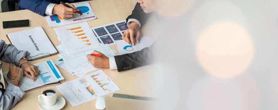 Smart businessman and businesswoman talking discussion in widen group meeting at office table in a modern office interior. Business collaboration strategic planning and brainstorming of coworkers.