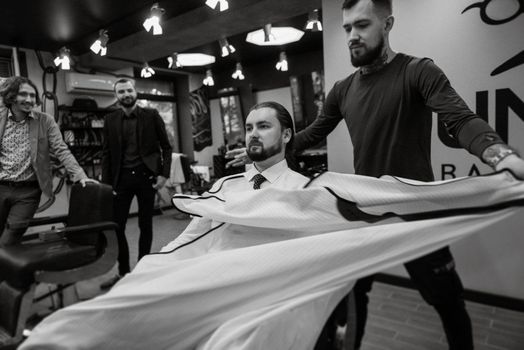 bearded man cutting his beard in the barbershop at the master