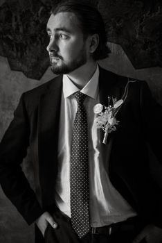 portrait of a male groom in a blue suit in the morning going to the barbershop on the wedding day