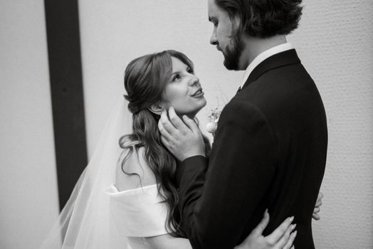 young couple bride and groom in a white dress walking