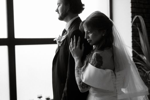 young couple bride and groom in a white dress walking