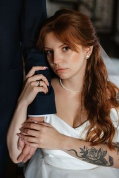 young couple bride and groom in a white dress walking