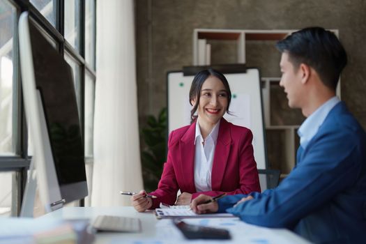 Beautiful business woman consultant talking with asian business person at meeting room with new financial market. Accounting concept.