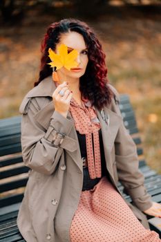 A woman walks outdoors in autumn, enjoys the autumn weather