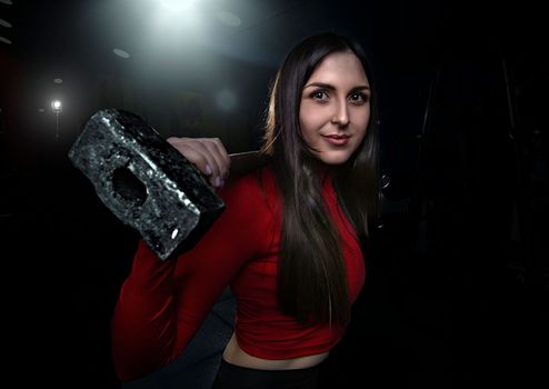 Strong woman doing weights.Sports lifestyle Beautiful fitness woman lifting dumbbells . Fitness sporty woman showing her well trained body. A beautiful girl's body with rippling muscles from strength training. High quality photo