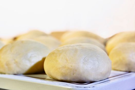 Balls of dough on white tray ,baking preparation
