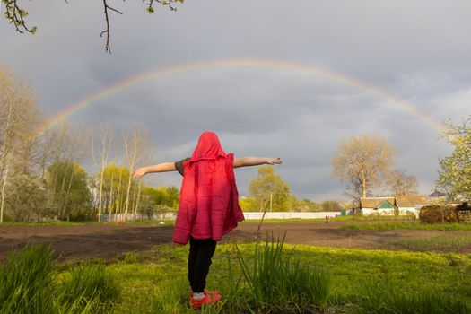 girl rejoices in the spring double rainbow , bright shots