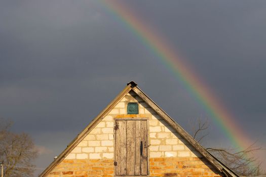 house and spring rainbow on blue sky , bright shots