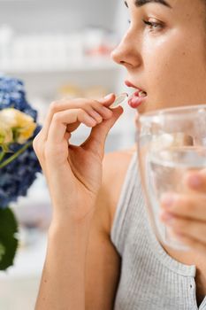 Girl is taking capsule of collagen supplement. Collagen pills to support skin health. BADS biologically active dietary supplements for healthcare