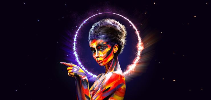 A girl in a glowing neon circle. Woman in color body painting on her face. Design for a nightclub or mall poster. Download a photo for a layout with discounts, promotions, announcements