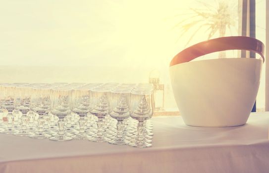 a row of empty glasses on a table at a wedding for laxative drinks Buffet