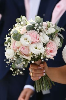 A bridal bouquet with roses, lisianthus, eucalyptus