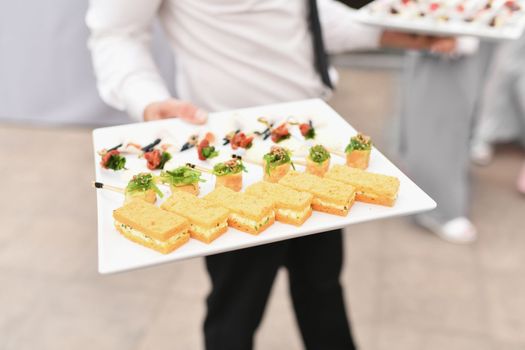 Waiter serving small appetizers at a wedding