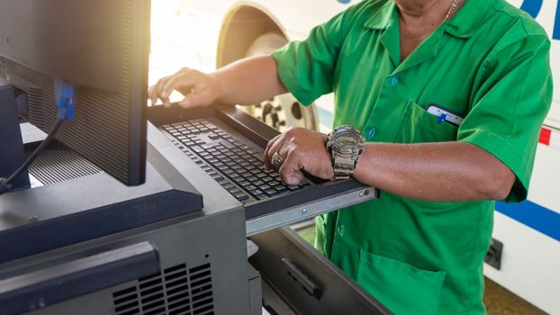 Unrecognizable Latino man performs bus mechanics in the computer