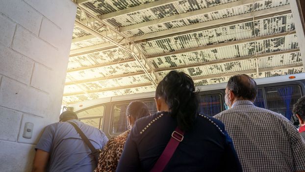 Latin American people waiting for the departure of a bus in a terrestrial terminal