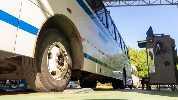 Parked bus while its brake system is inspected with a specialized machine