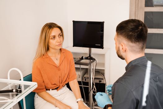 Visiting ENT doctor for examination of the state of health of the ear, throat and nose. Consultation of woman with otolaryngologist in a medical clinic