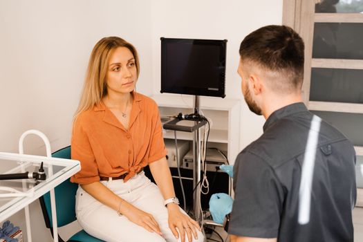 Visiting ENT doctor for examination of the state of health of the ear, throat and nose. Consultation of woman with otolaryngologist in a medical clinic