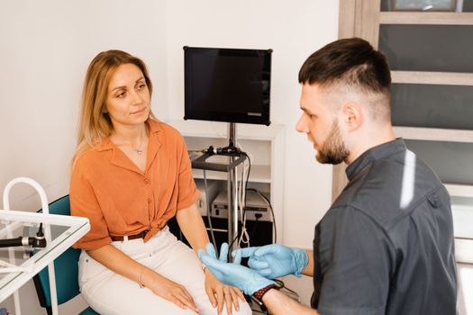 Woman visit ENT doctor. Consultation of woman with otolaryngologist in a medical clinic