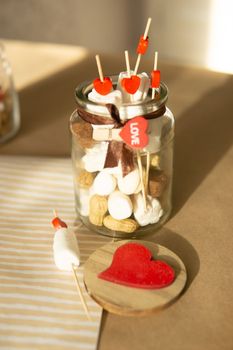 sweet gift for Valentine's Day with your own hands. A gift for the holiday made of heart-shaped candies and marshmallows.