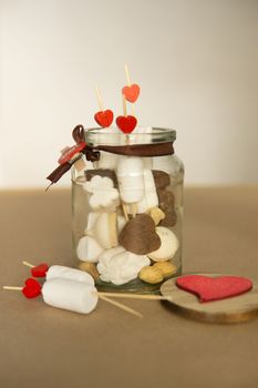 sweet gift for Valentine's Day with your own hands. A gift for the holiday made of heart-shaped candies and marshmallows.