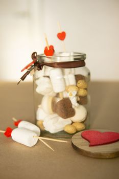 sweet gift for Valentine's Day with your own hands. A gift for the holiday made of heart-shaped candies and marshmallows.