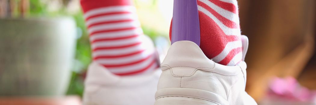 Wear athletic shoes with shoe spoon. Shoe care and wearing rules concept
