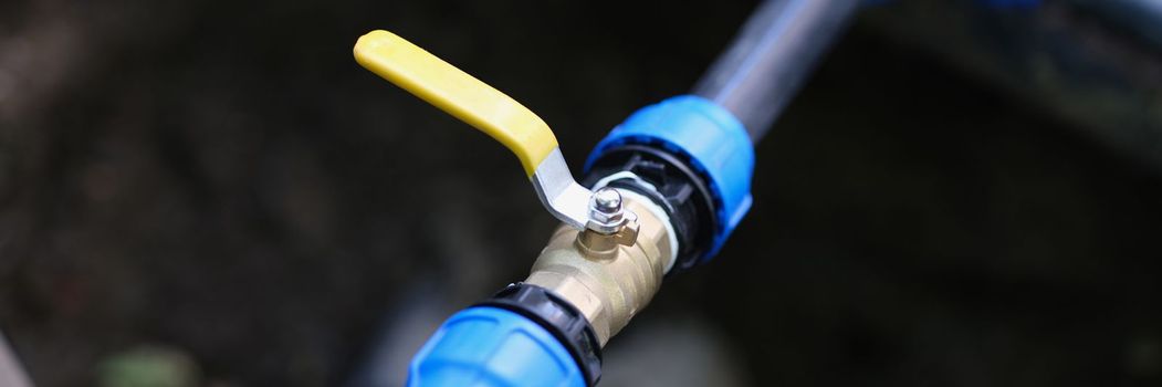 Closeup of pvc pipes with tap or faucet. Installation and management of underground irrigation system and tap water drainage