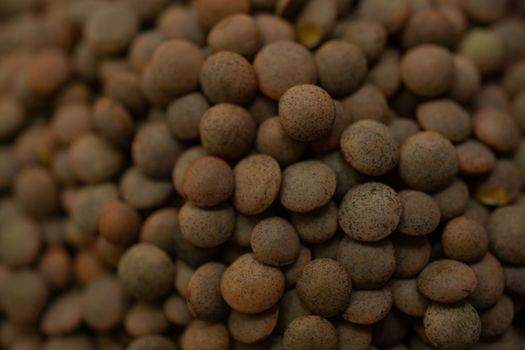 close-up detail of unfocused brown lentils macro photography