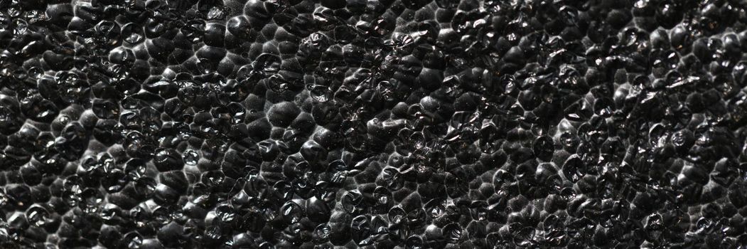 Black rough concrete gravel wall background texture. Black abstract concept