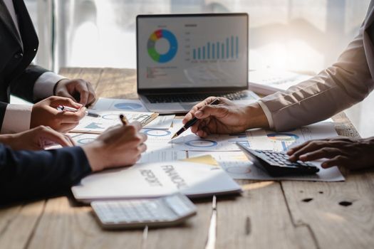 Close up of Diverse colleagues gather brainstorm discuss financial statistics at office meeting. finance, teamwork concept.