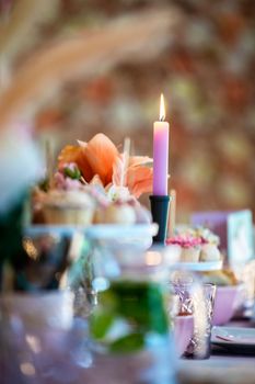 Table setting at a luxury wedding or party, babyshower, birthday and Beautiful flowers, cake,candles decortation on the table. High tea