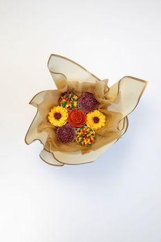 Cupcake decorated with white various colors flower icing isolated on white background. Shoot from top. Floral bouquet. Wedding cupcakes. Mothers Day,Birthday, Valentine Holiday Romantic