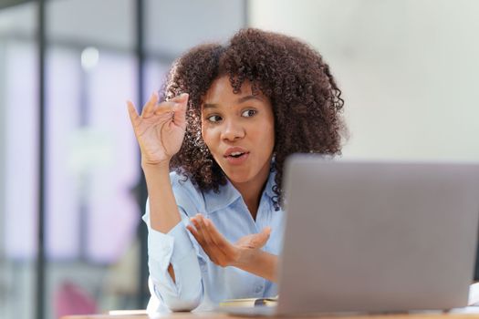 Attractive black businesswoman using laptop video conference call, business colleagues. Communicating with team.