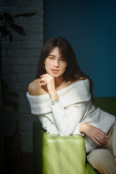 Beautiful young brunette woman portrait. white angora sweater