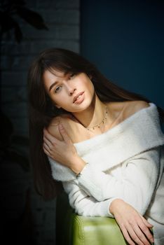 Beautiful young brunette woman portrait. white angora sweater