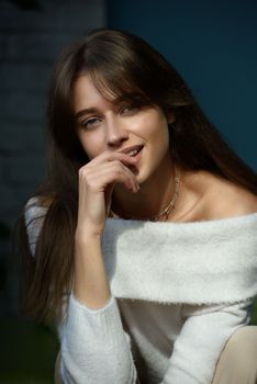 Beautiful young brunette woman portrait. white angora sweater