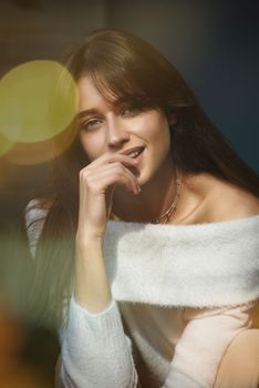 Beautiful young brunette woman portrait. white angora sweater