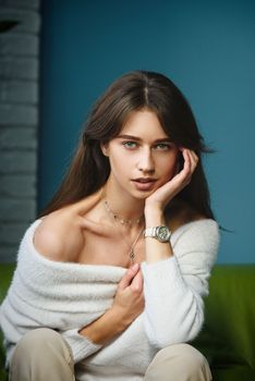 Beautiful young brunette woman portrait. white angora sweater