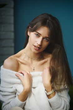 Beautiful young brunette woman portrait. white angora sweater