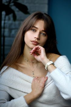 Beautiful young brunette woman portrait. white angora sweater