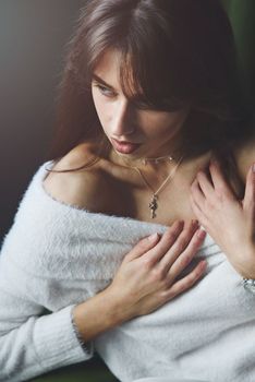 Beautiful young brunette woman portrait. white angora sweater