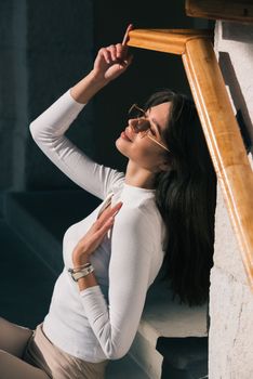 Photo of cheerful glad nice woman toothy beaming smile wear sunglass enjoying the sun. shirt urban city outside