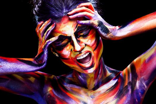 Portrait of the bright beautiful young woman with art make-up on dark background