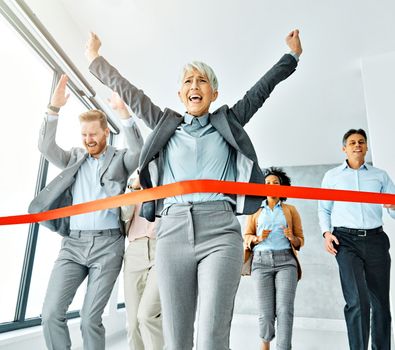 Group of young and senior business people having fun organizing a race during a meeting in the office. Teamwork and success concept