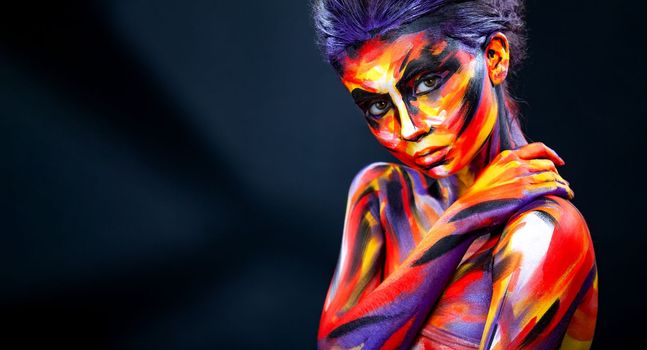 Portrait of the bright beautiful girl with art colorful make-up and bodyart. Download a picture with free space for text. Mockup for a music album. Cover design for e-book. Abstract image.